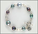 Bracelet fait main 1 perle semi-ronde 12,15mm cat C 7 semi-baroques baroques et cerclées 8,25 à 10,85mm cat A et argent (brpsx10085)